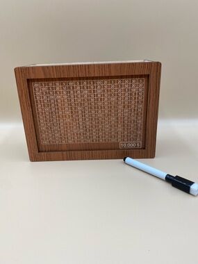 Wood Grain piggy bank Frame with White Grid cross off amounts to get to $10,000